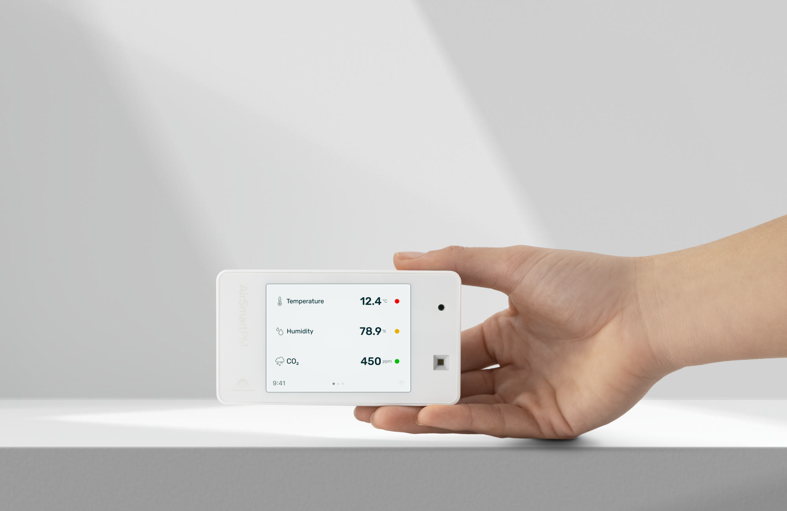 AirSmart air quality monitor held in a hand